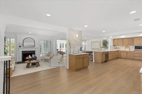 a living room with furniture and kitchen view