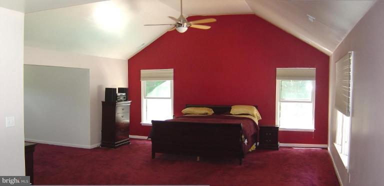 622 Church Road Reisterstown, MD 21136 - Photo 13 of 21 a bedroom with a bed and a chandelier