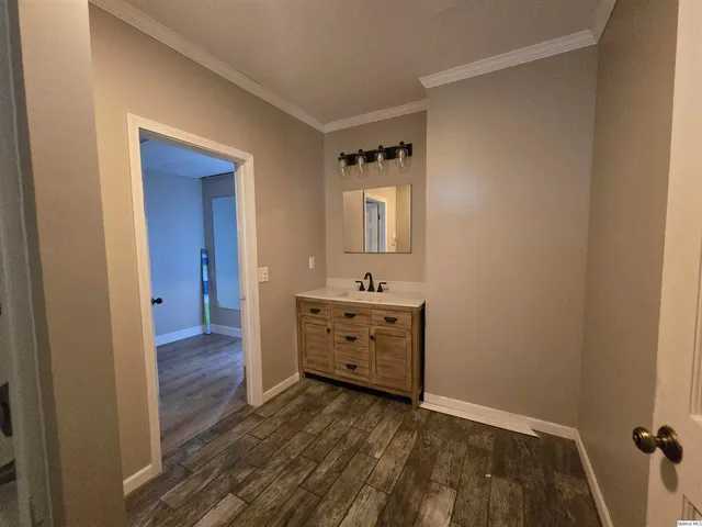 a view of a hallway with closet and wooden floor