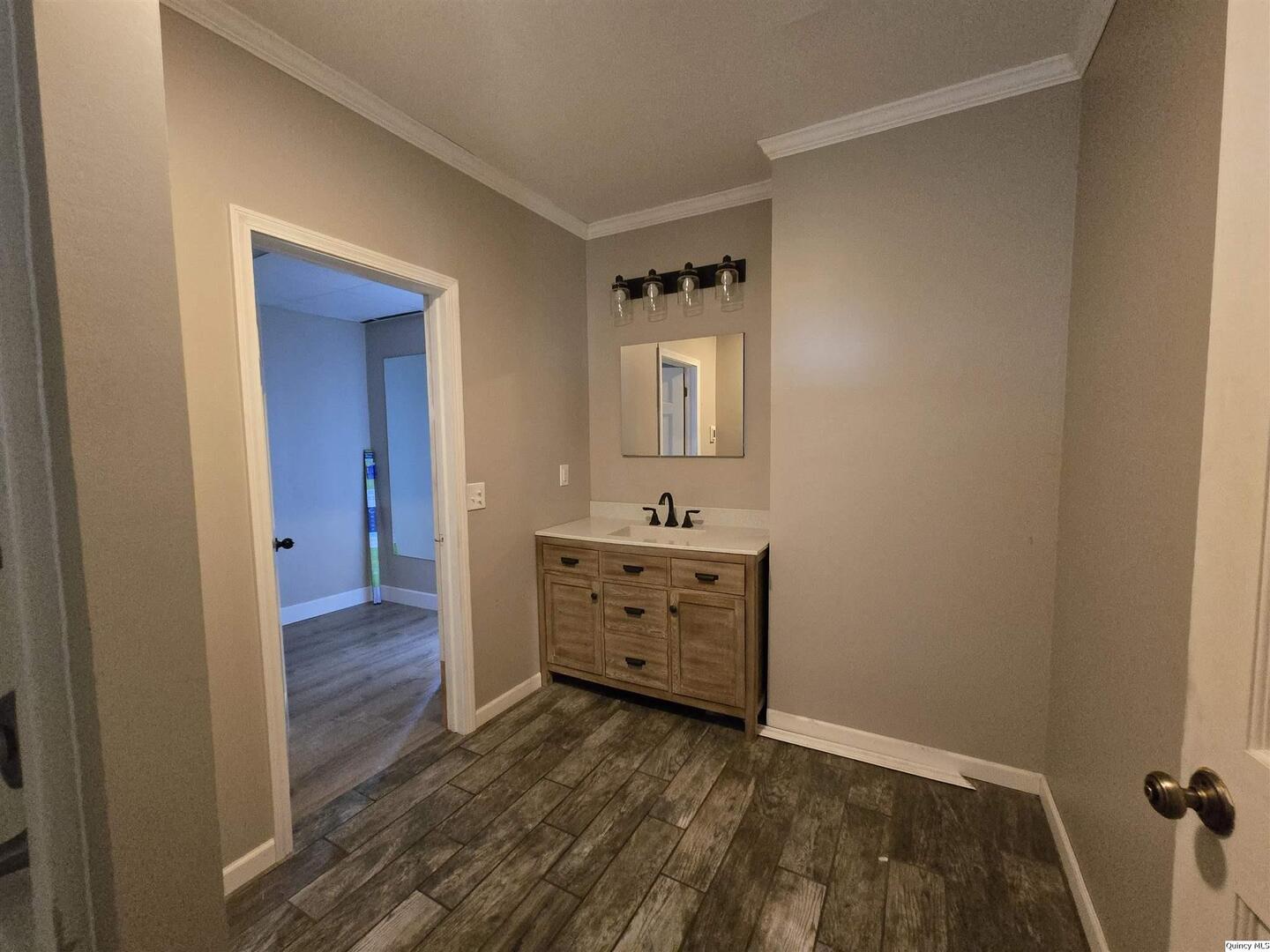 112 North Walnut Street Versailles, IL 62378 - Photo 11 of 18 a view of a hallway with closet and wooden floor