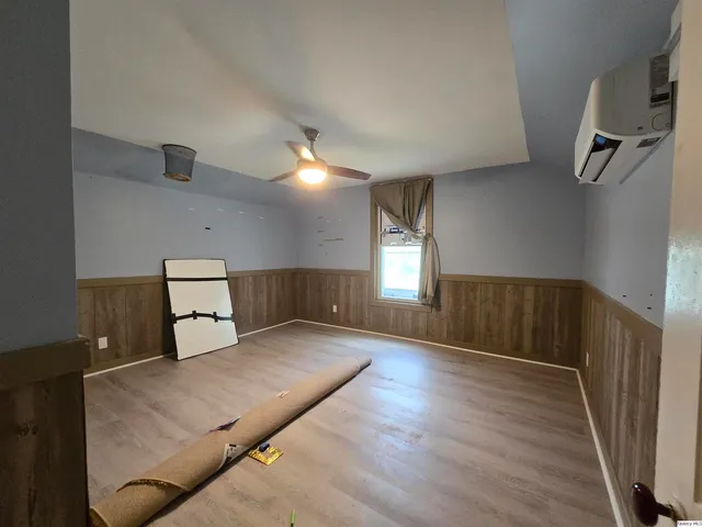 a spacious bedroom with a bed and window