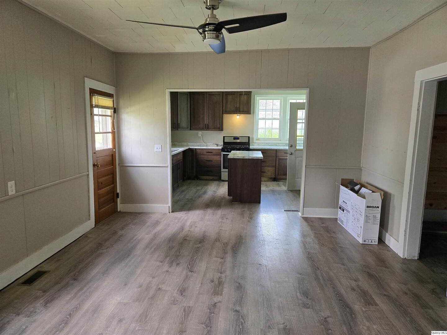 112 North Walnut Street Versailles, IL 62378 - Photo 4 of 18 a living room with furniture and a wooden floor