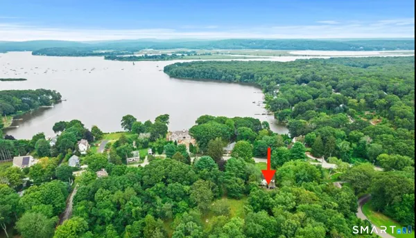 an aerial view of a houses with outdoor space and ocean view