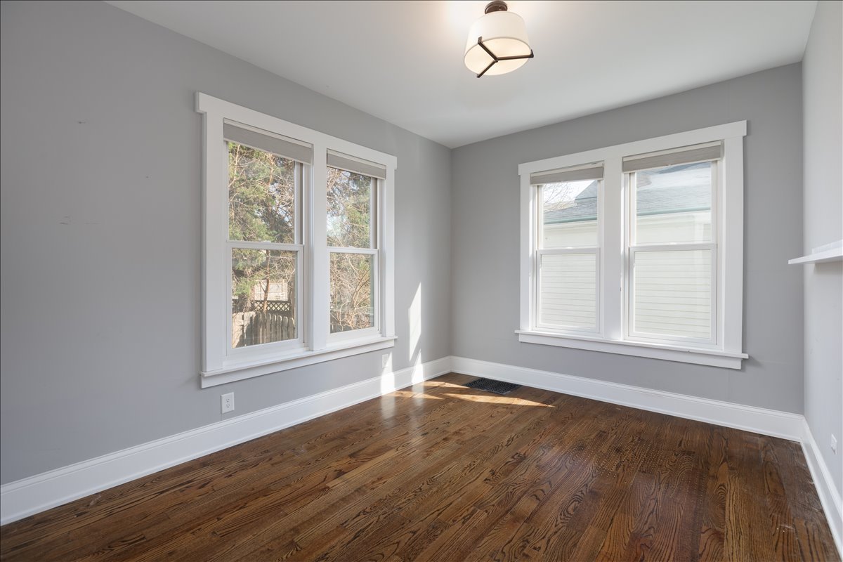 18 North Main Street Naperville, IL 60540 - Photo 11 of 32 an empty room with wooden floor and windows