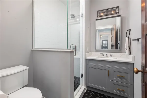 a bathroom with a toilet sink and mirror