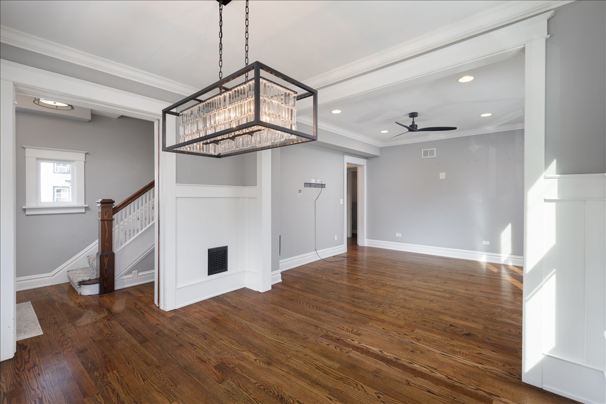 18 North Main Street Naperville, IL 60540 - Photo 15 of 32 a view of a livingroom with wooden floor and a ceiling fan