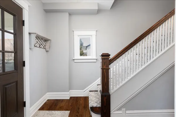 a view of entryway and hall with wooden floor