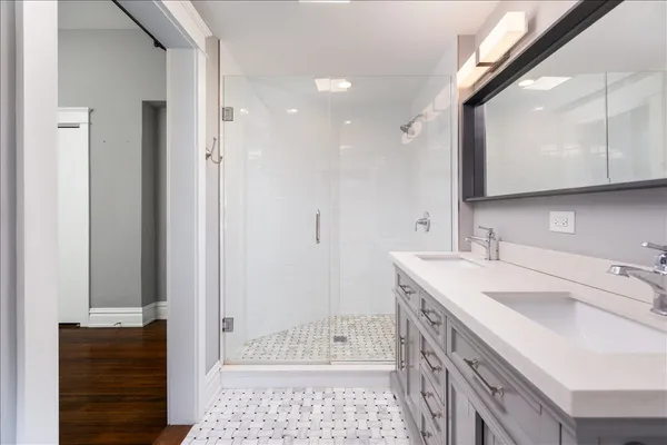 a bathroom with a sink a toilet and shower