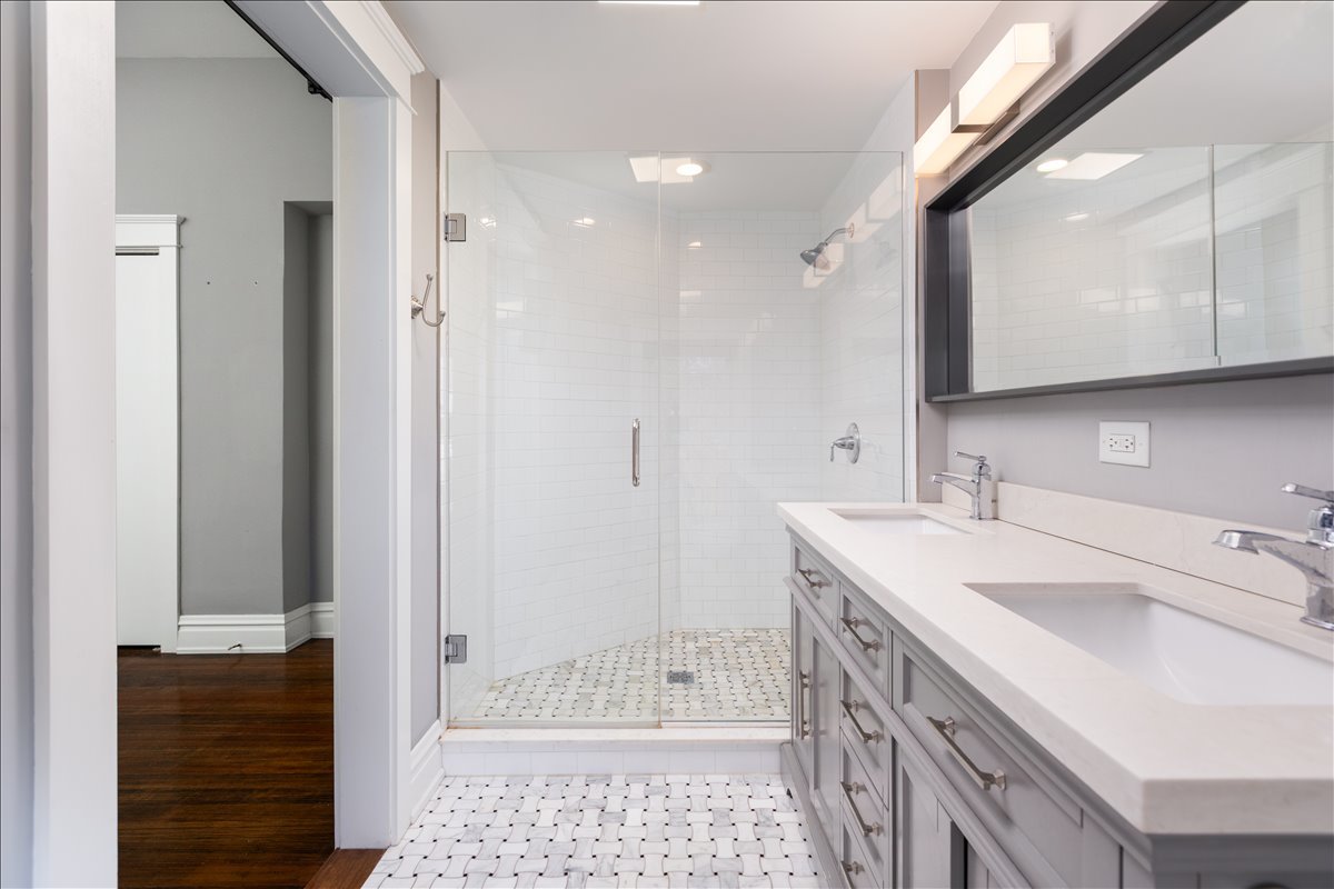 18 North Main Street Naperville, IL 60540 - Photo 21 of 32 a bathroom with a sink a toilet and shower