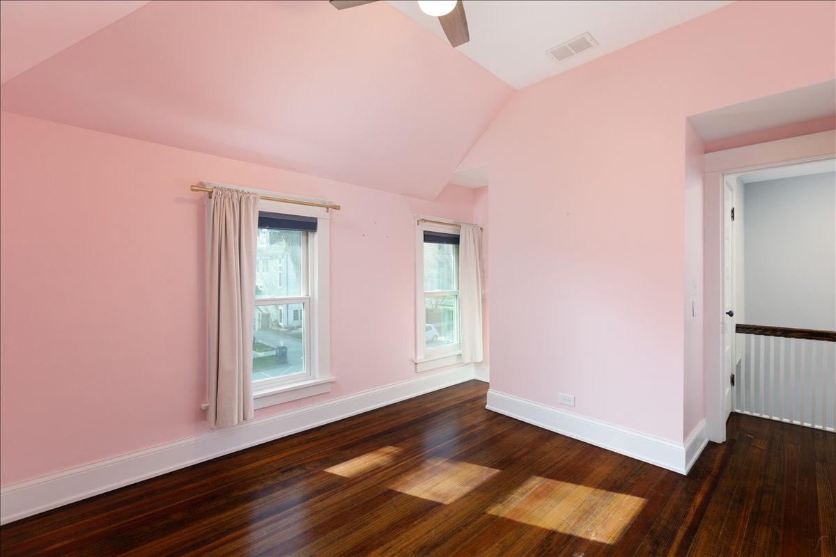 18 North Main Street Naperville, IL 60540 - Photo 25 of 32 an empty room with wooden floor and windows