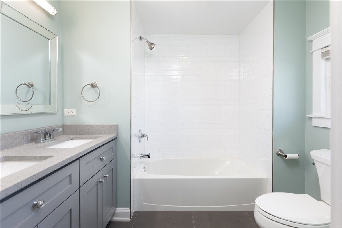 18 North Main Street Naperville, IL 60540 - Photo 26 of 32 a bathroom with a granite countertop toilet sink and a bathtub