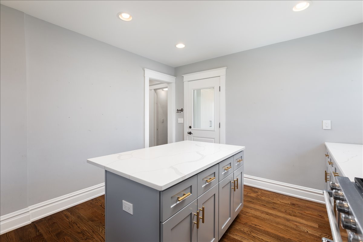 18 North Main Street Naperville, IL 60540 - Photo 9 of 32 a kitchen with a sink window and wooden floor