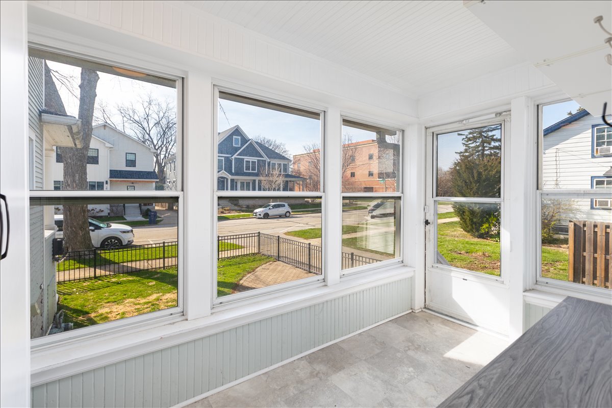 18 North Main Street Naperville, IL 60540 - Photo 10 of 32 a view of an empty room with wooden floor and a window