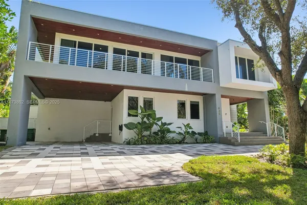 a front view of a house with a yard outdoor seating and pathway