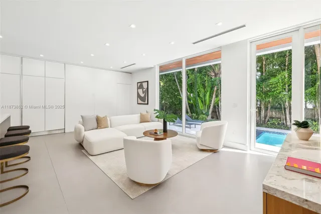 a view of kitchen with stainless steel appliances granite countertop a sink and a large window
