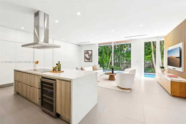 a spacious bedroom with a bed a couch and a flat screen tv