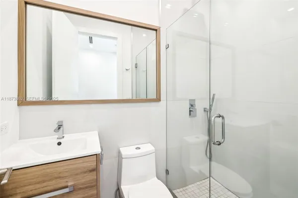 a white toilet sitting next to a shower curtain