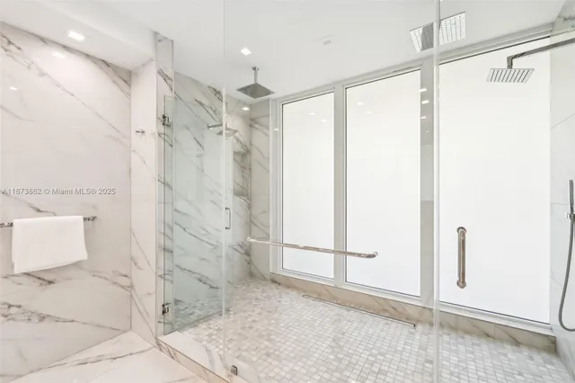 a bathroom with a toilet sink vanity and shower