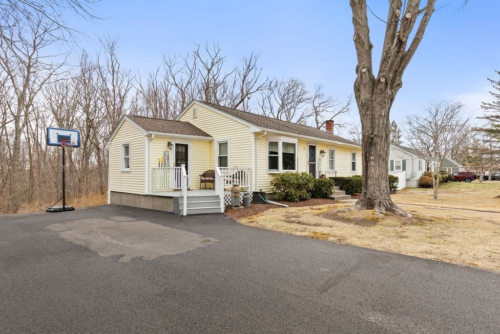 a view of a house with a yard covered in snow