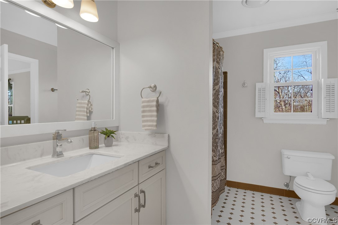 8307 Spring Meadow Road North Chesterfield, VA 23235 - Photo 33 of 47 a bathroom with a sink a toilet and a mirror