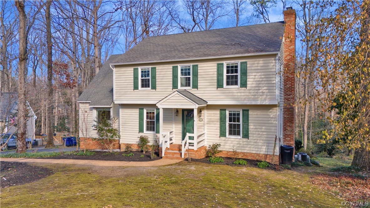 8307 Spring Meadow Road North Chesterfield, VA 23235 - Photo 47 of 47 a front view of a house with a yard and garage