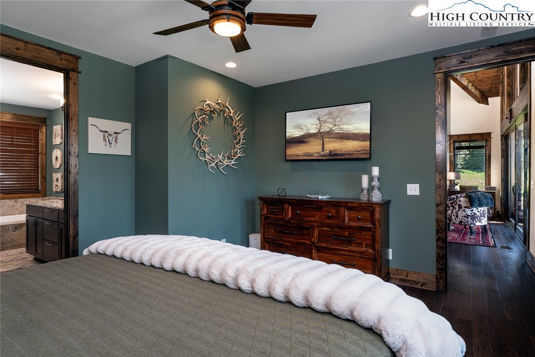 344 High Country Overlook Banner Elk, NC 28604 - Photo 13 of 48 a bedroom with a bed and a chandelier