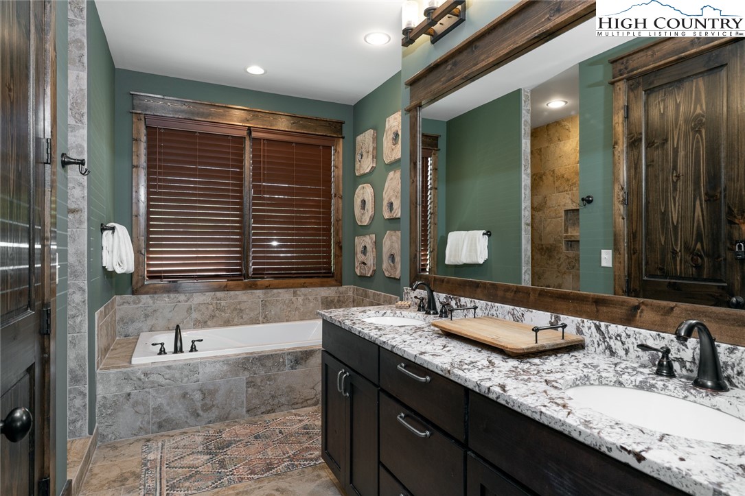 344 High Country Overlook Banner Elk, NC 28604 - Photo 15 of 48 a bathroom with a granite countertop sink and a mirror