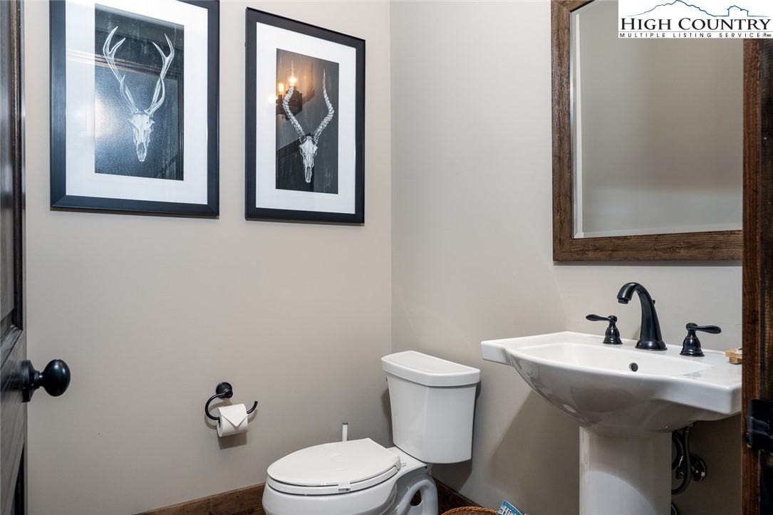 344 High Country Overlook Banner Elk, NC 28604 - Photo 18 of 48 a bathroom with a toilet sink and mirror