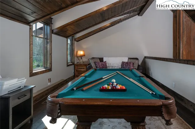 a room with pool table table soccer and a chandelier