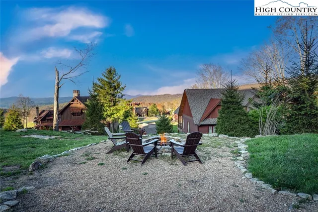 a view of a backyard with sitting area