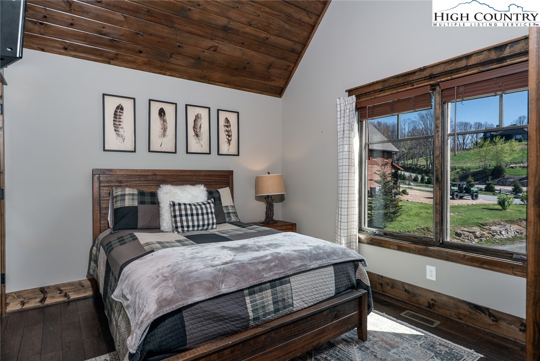 344 High Country Overlook Banner Elk, NC 28604 - Photo 23 of 48 a bedroom with a large bed and a large window with outer view