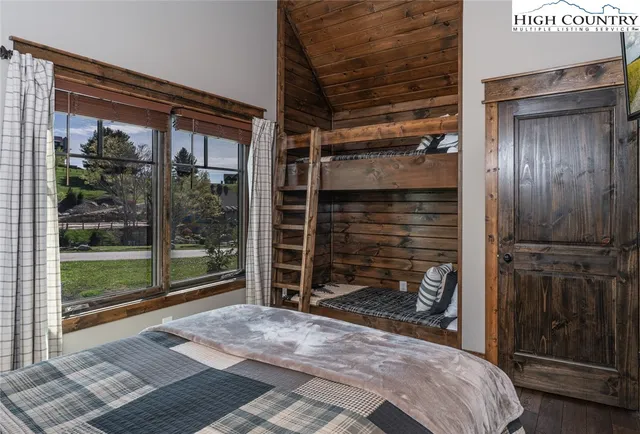 a bedroom with a bed and painting on the wall