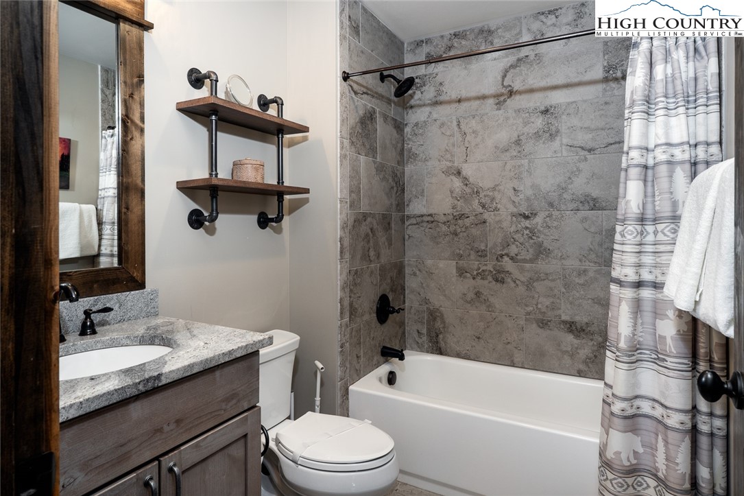 344 High Country Overlook Banner Elk, NC 28604 - Photo 31 of 48 a bathroom with a granite countertop bathtub shower sink vanity and toilet