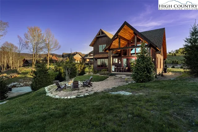 a view of a backyard with a patio and outdoor seating