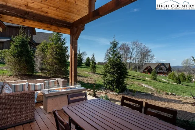 a view of backyard with outdoor seating a patio and plants