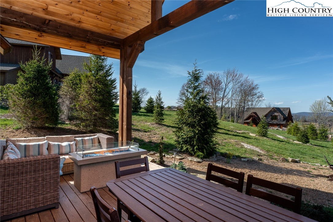 344 High Country Overlook Banner Elk, NC 28604 - Photo 34 of 48 a view of roof deck with table and chairs couches with wooden floor and fence