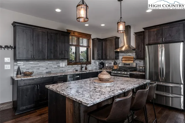 a kitchen with sink a refrigerator and wooden cabinets