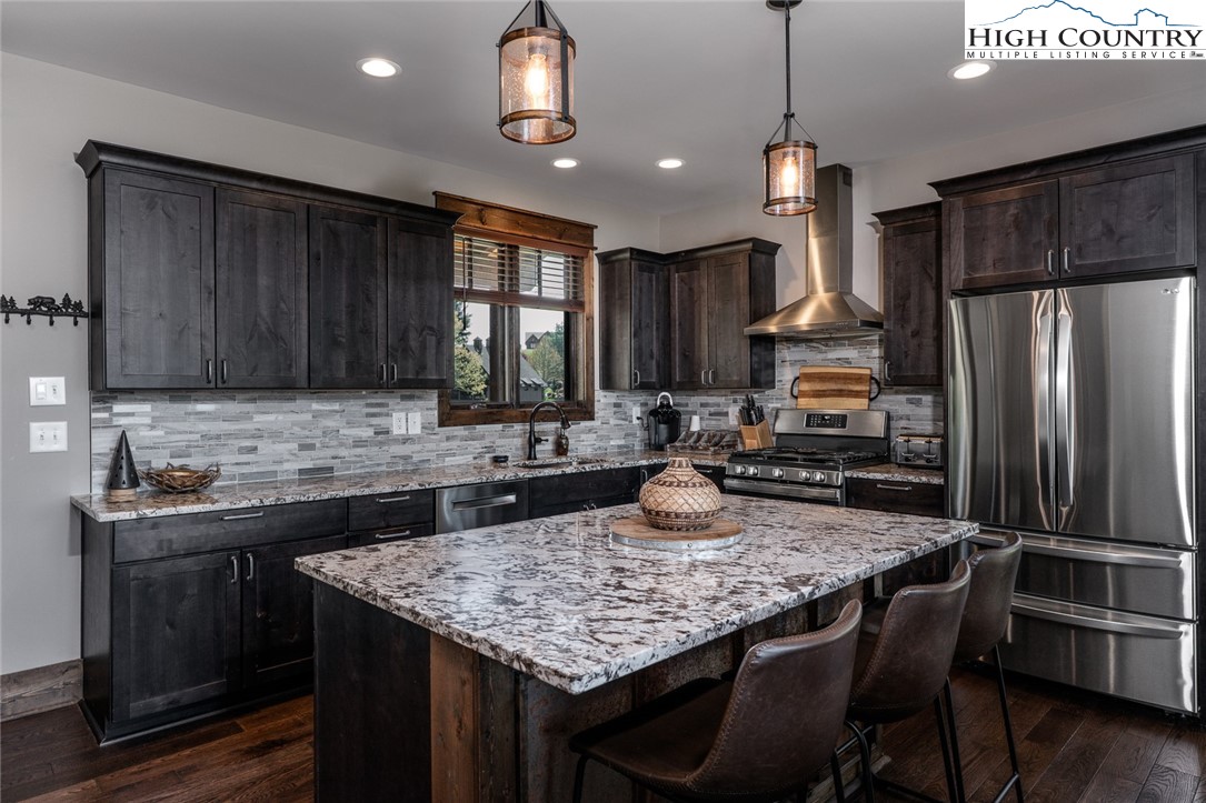 344 High Country Overlook Banner Elk, NC 28604 - Photo 7 of 48 a kitchen with sink a refrigerator and wooden cabinets