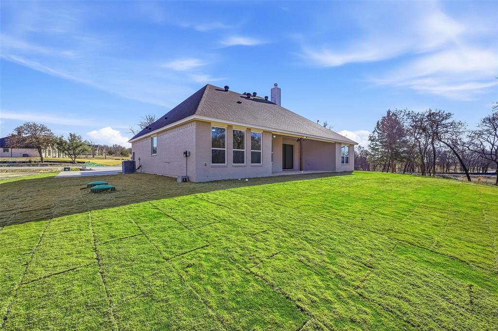 1053 Llano Way Poolville, TX 76487 - Photo 39 of 40 a view of a house with a yard