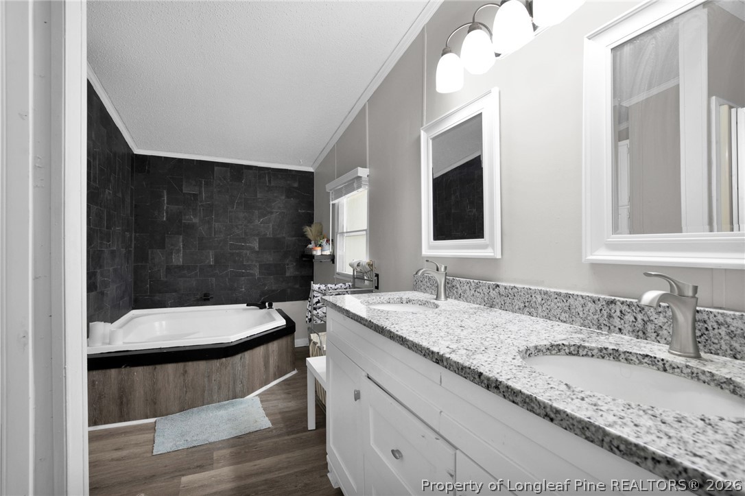 518 Inverary Drive Raeford, NC 28376 - Photo 18 of 30 a bathroom with a granite countertop double vanity sink and mirror