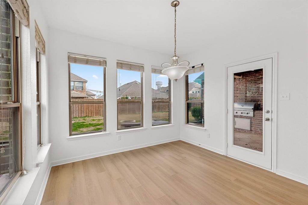 174 Hampton Drive Fate, TX 75087 - Photo 11 of 40 a view of an empty room with a window and wooden floor