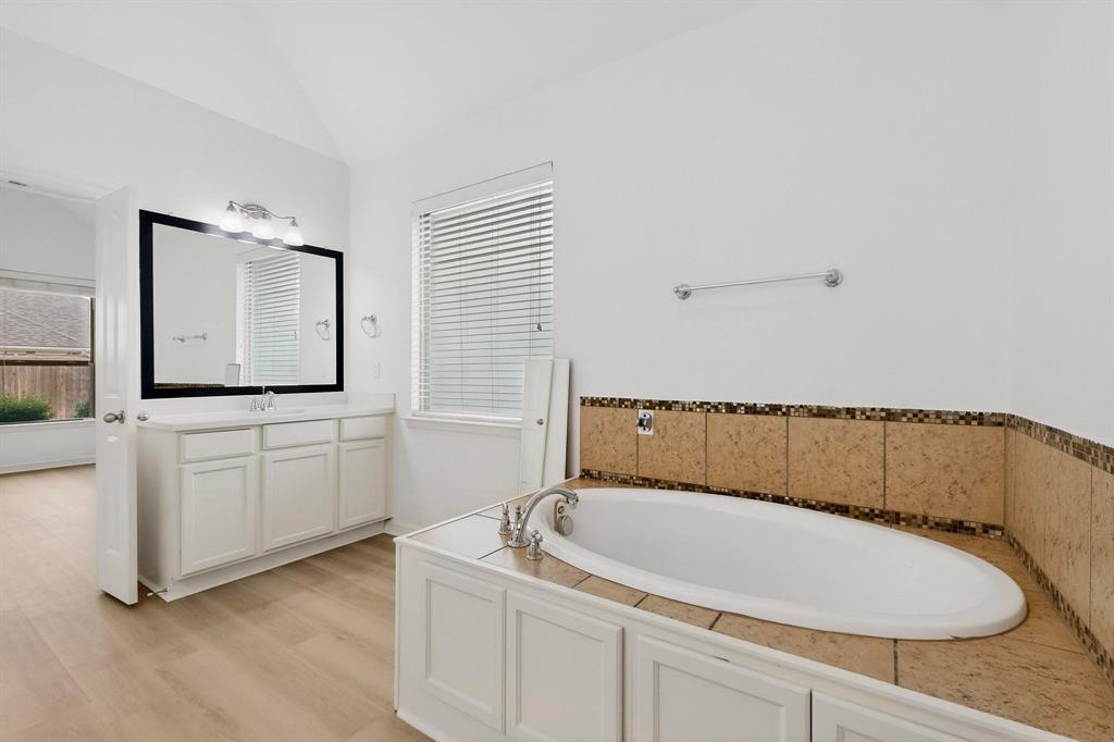 174 Hampton Drive Fate, TX 75087 - Photo 16 of 40 a bathroom with a granite countertop sink and mirror