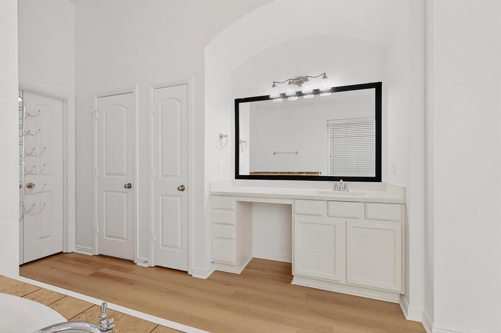 174 Hampton Drive Fate, TX 75087 - Photo 17 of 40 a view of a room with wooden floor and mirror