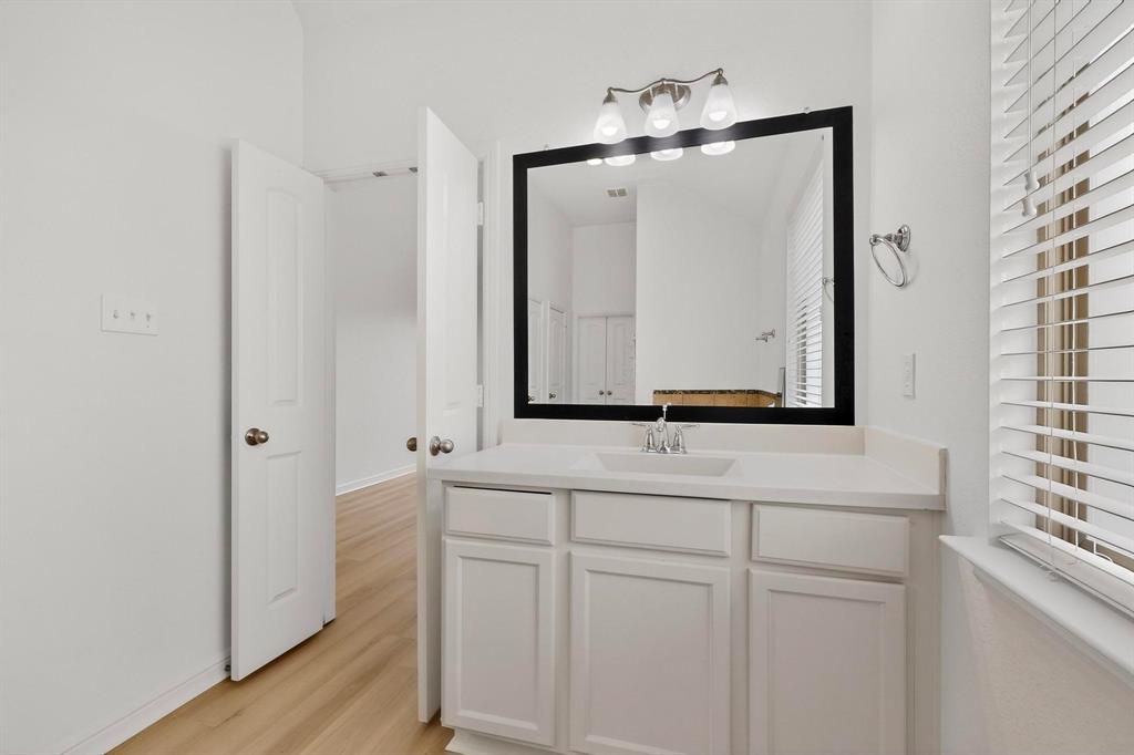 174 Hampton Drive Fate, TX 75087 - Photo 18 of 40 a bathroom with a double vanity sink and mirror