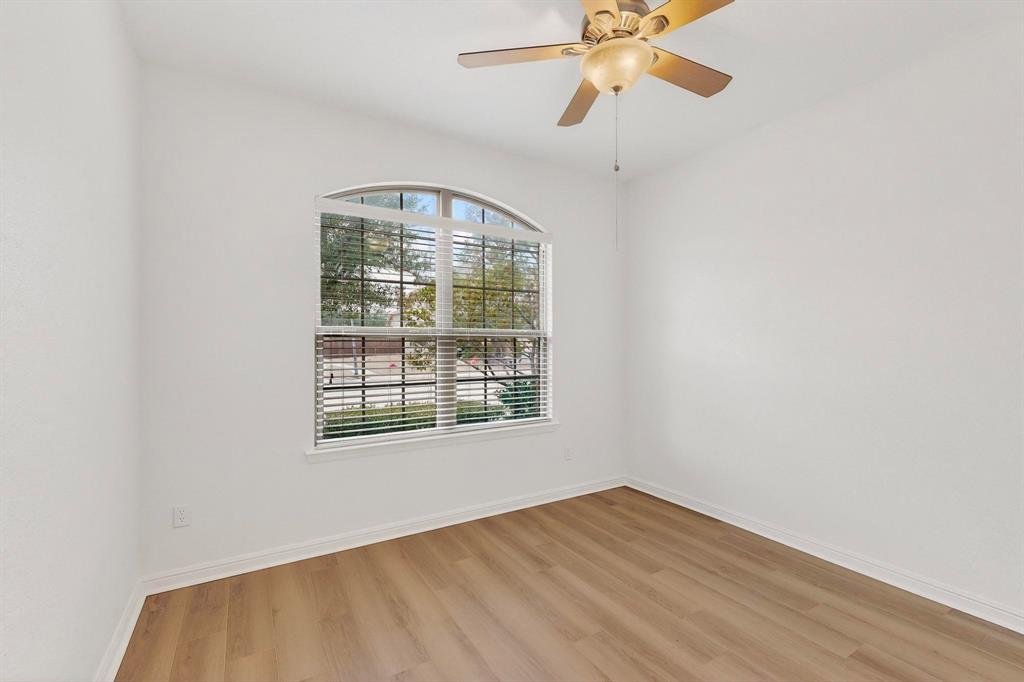 174 Hampton Drive Fate, TX 75087 - Photo 20 of 40 an empty room with wooden floor fan and windows