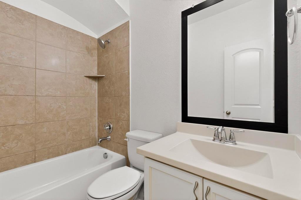 174 Hampton Drive Fate, TX 75087 - Photo 22 of 40 a bathroom with a sink toilet vanity and shower