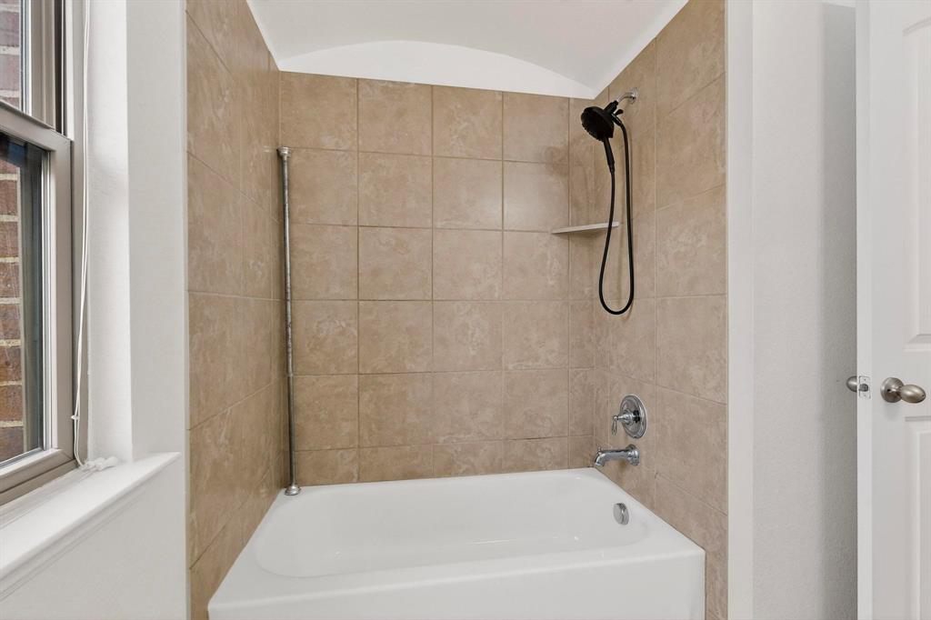 174 Hampton Drive Fate, TX 75087 - Photo 28 of 40 a bathroom with a bath tub with a shower