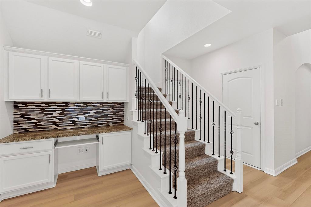 174 Hampton Drive Fate, TX 75087 - Photo 3 of 40 a view of a kitchen with wooden floor and electronic appliances