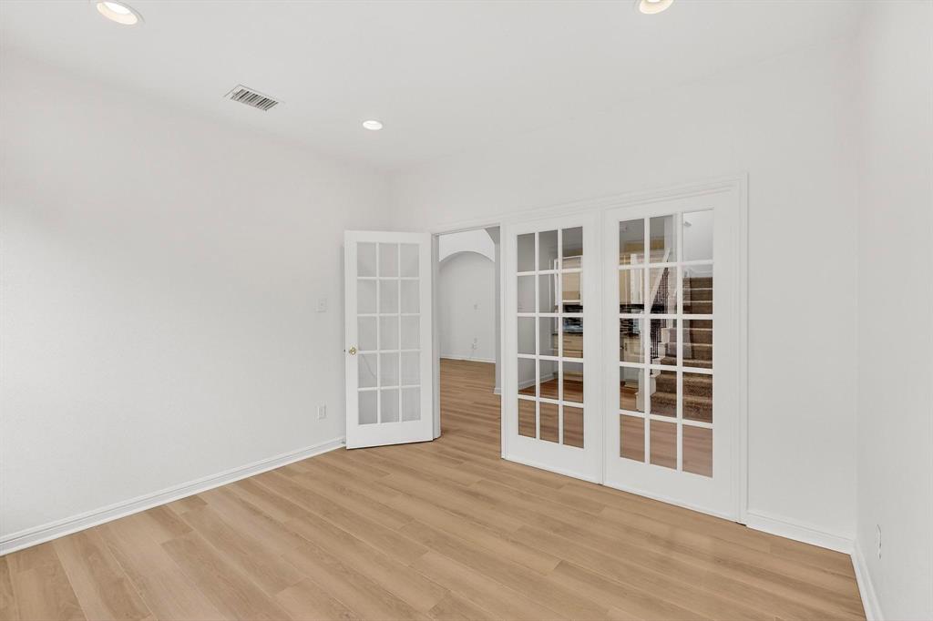 174 Hampton Drive Fate, TX 75087 - Photo 34 of 40 an empty room with wooden floor and windows