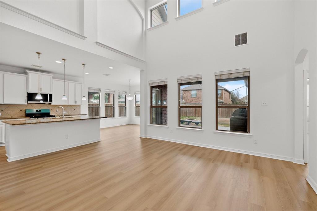 174 Hampton Drive Fate, TX 75087 - Photo 4 of 40 a view of large kitchen with stainless steel appliances granite countertop cabinets and wooden floor